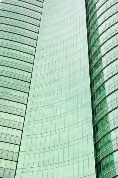 Modern green glass skyscraper perspective view