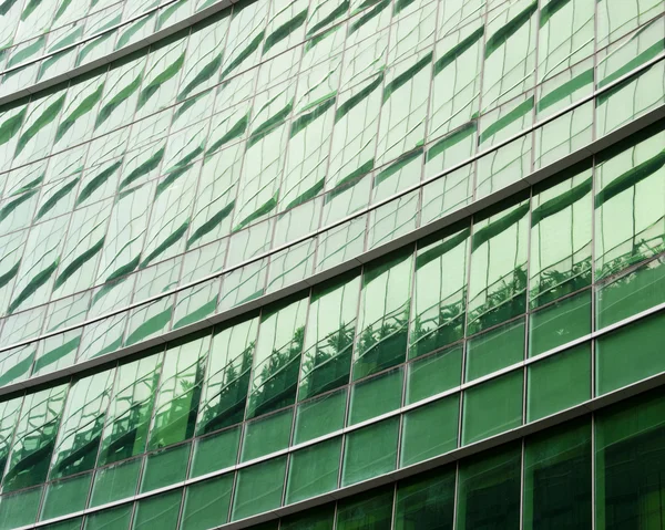 Modern green glass skyscraper perspective view — Stock Photo, Image