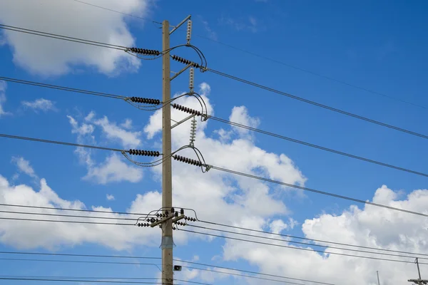 Power lines on the blue sky with cloudy background — Stock Photo, Image