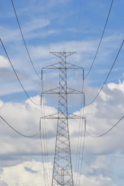 Power lines on the blue sky with cloudy background — Stock Photo, Image