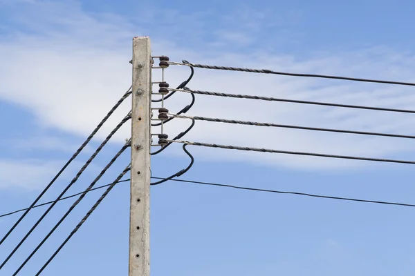 Power lines on the blue sky with cloudy background — Stock Photo, Image