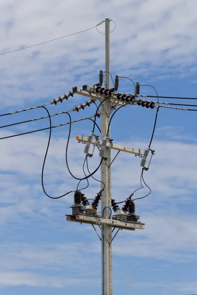 Power lines on the blue sky with cloudy background — Stock Photo, Image