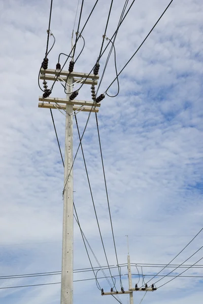 Power lines on the blue sky with cloudy background — Stock Photo, Image