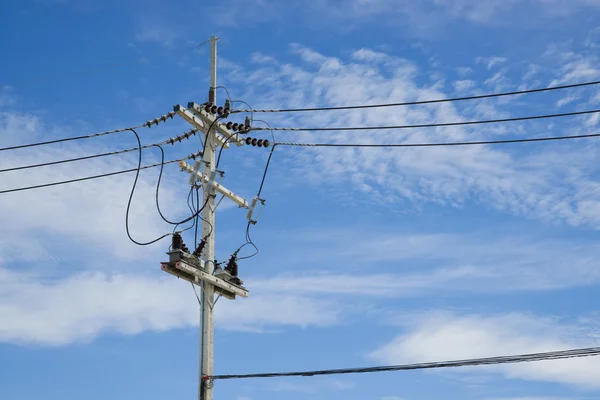 Power lines on the blue sky with cloudy background — Stock Photo, Image