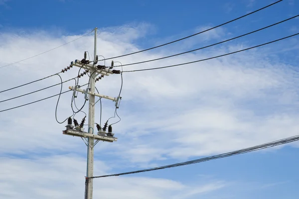 Power lines on the blue sky with cloudy background — Stock Photo, Image