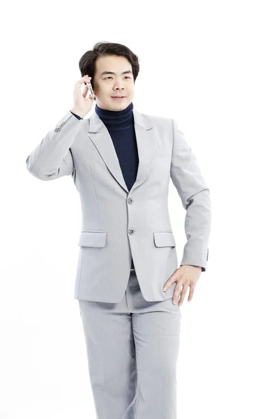 Businessman making a phone call against a white background — Stock Photo, Image