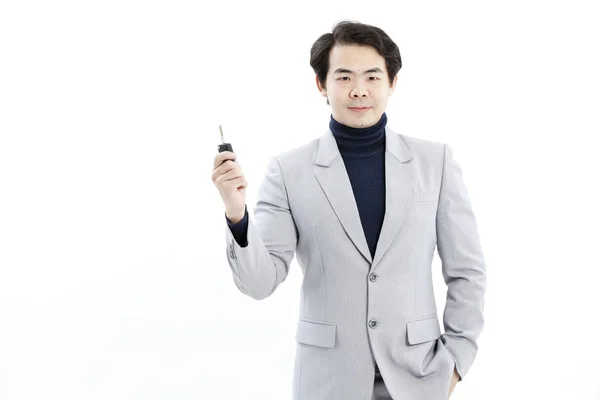 Concept image of a businessman holding a key — Stock Photo, Image