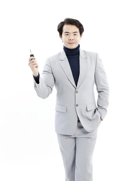 Concept image of a businessman holding a key — Stock Photo, Image