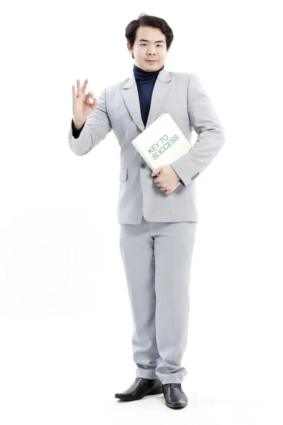 Successful businessman with book and ok sign — Stock Photo, Image