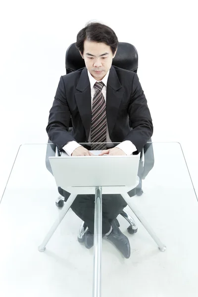 Portrait of handsome young business man using computer Stock Picture