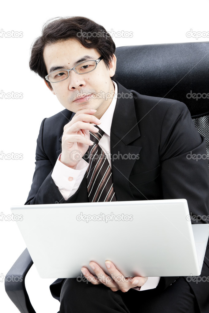 Portrait of handsome young business man using new laptop