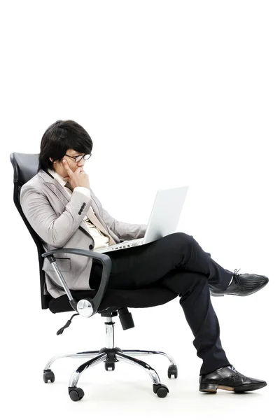 Young business man using new laptop and thinking — Stock Photo, Image