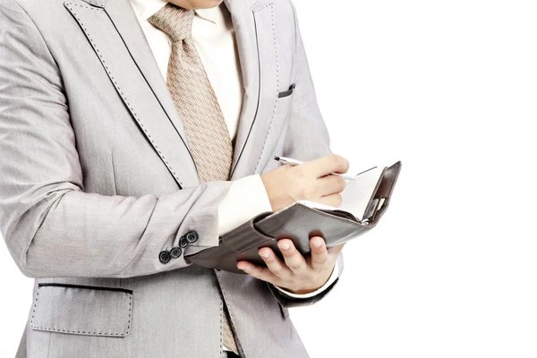 Businessman writing in office — Stok fotoğraf