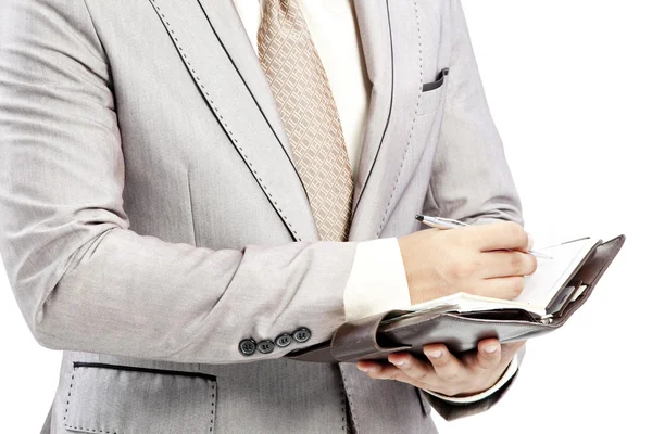 Businessman writing in office — Stockfoto