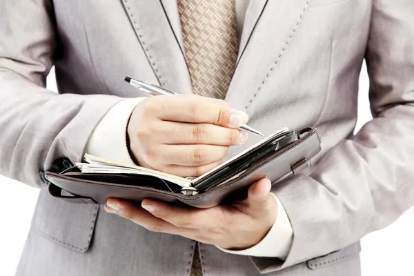 Businessman writing in office — Stok fotoğraf