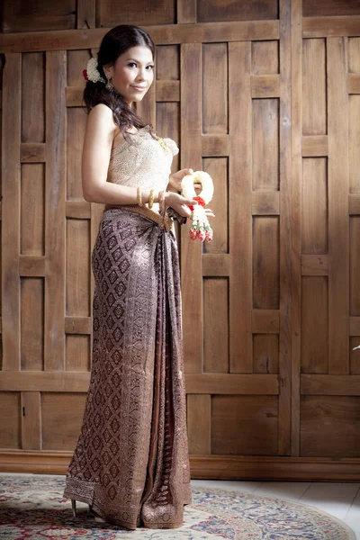 Portrait Gorgeous asian woman in thai dress near wooden wall — Stock Photo, Image