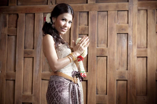 Portrait Gorgeous asian woman in thai dress near wooden wall — Stock Photo, Image