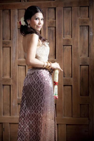 Πορτρέτο πανέμορφο ασιατική γυναίκα σε Ταϊλάνδης φόρεμα κοντά ξύλινα τοίχων — Φωτογραφία Αρχείου