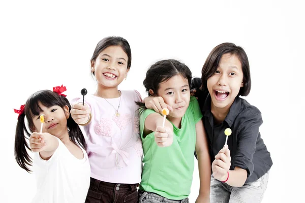 Groep van kleine leuke grappige Aziatische meisjes met kleurrijke lollipop snoep — Stockfoto