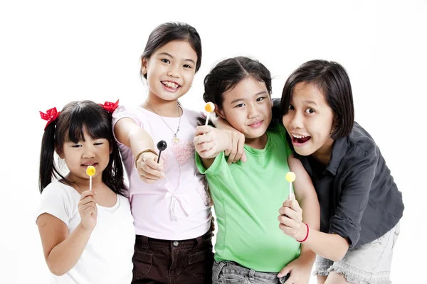 Group of little cute funny asian girls with colorful lollipop candy — Stock Photo, Image