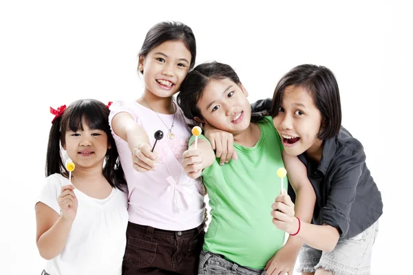 Group of little cute funny asian girls with colorful lollipop candy — Stock Photo, Image