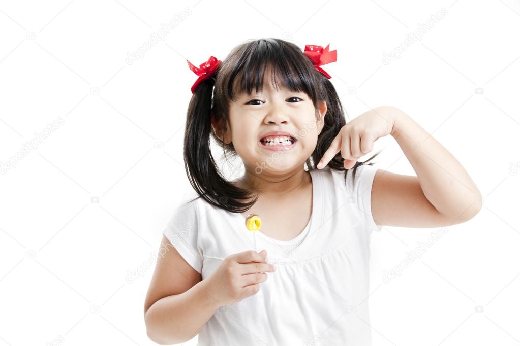 Little cute funny asian girl with colorful lollipop candy