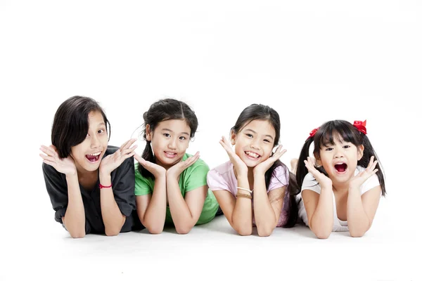 Group of little asian girls lying on floor isolated on white — Stock Photo, Image