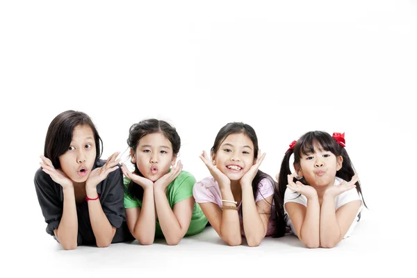 Group of little asian girls lying on floor isolated on white — Stock Photo, Image