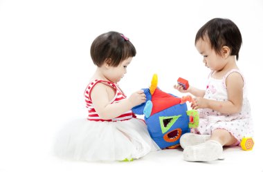 iki şirin Asyalı kız oyuncakla oynamak portre