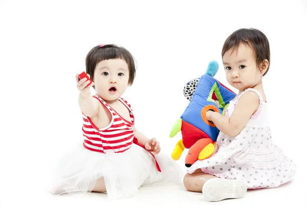 Portrait of two cute asian girls playing with toy — Stock Photo, Image