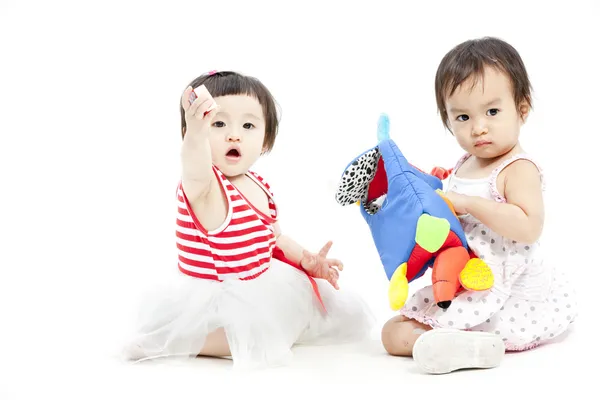 Portret van twee leuke Aziatische meisjes spelen met speelgoed — Stockfoto