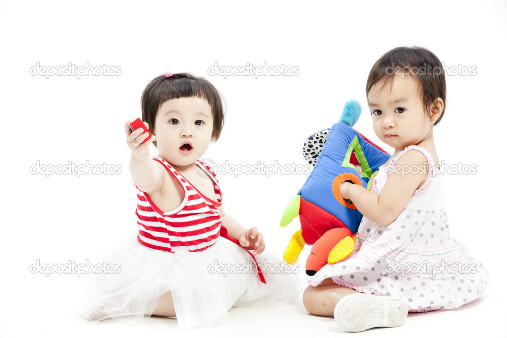 Portrait of two cute asian girls playing with toy