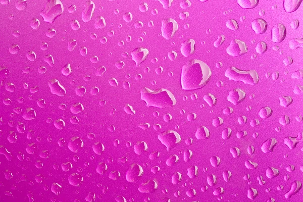 Close-up of water drops on metal surface as background. Pink — Stock Photo, Image