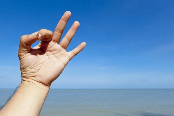 Ok hand sign with beach background — Stock Photo, Image