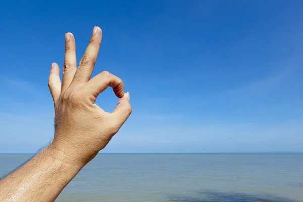 Ok hand sign with beach background — Stock Photo, Image
