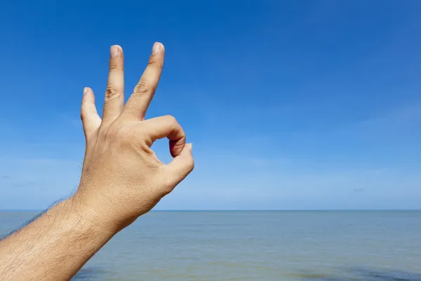 Ok hand sign with beach background — Stock Photo, Image