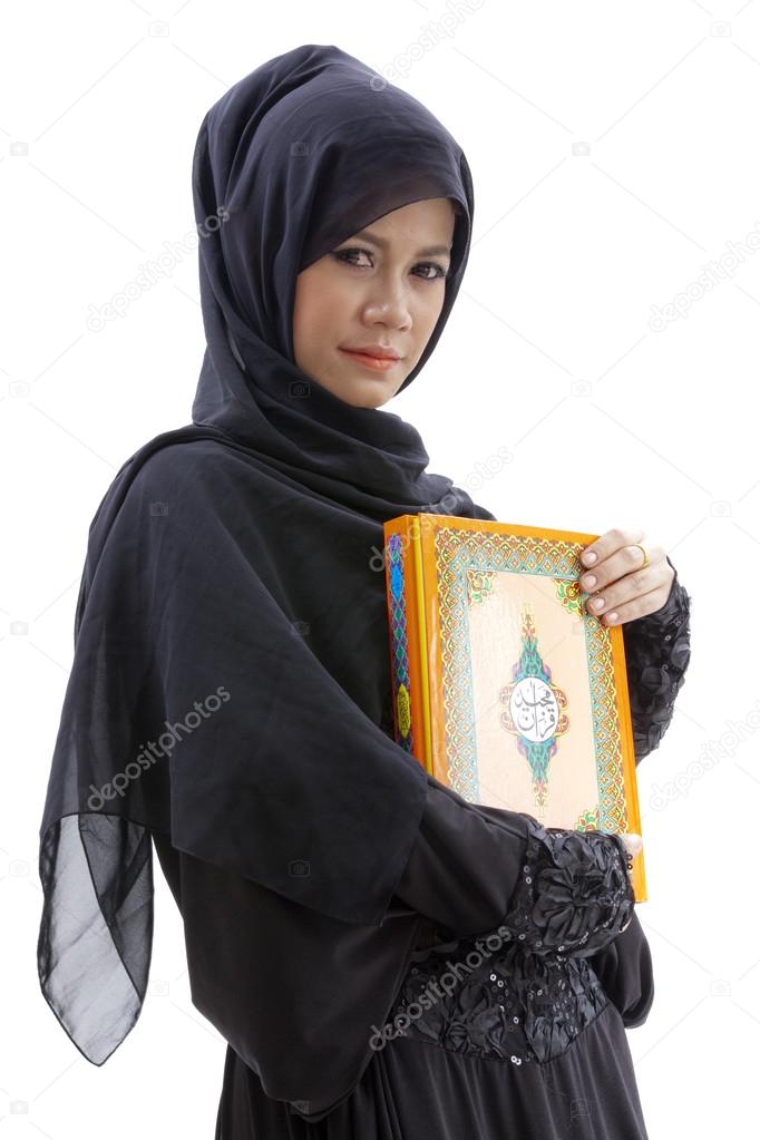 Muslim woman holding holy koran