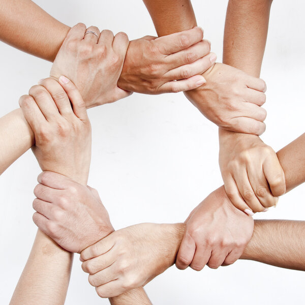 Small group of business people joining hands