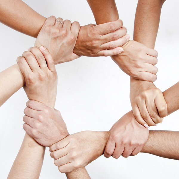 Small group of business people joining hands