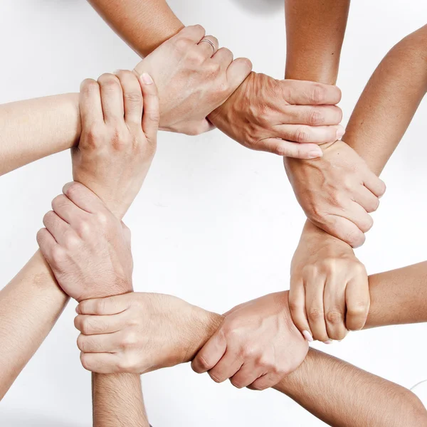 Kleine groep van mensen uit het bedrijfsleven toetreding tot de handen — Stockfoto