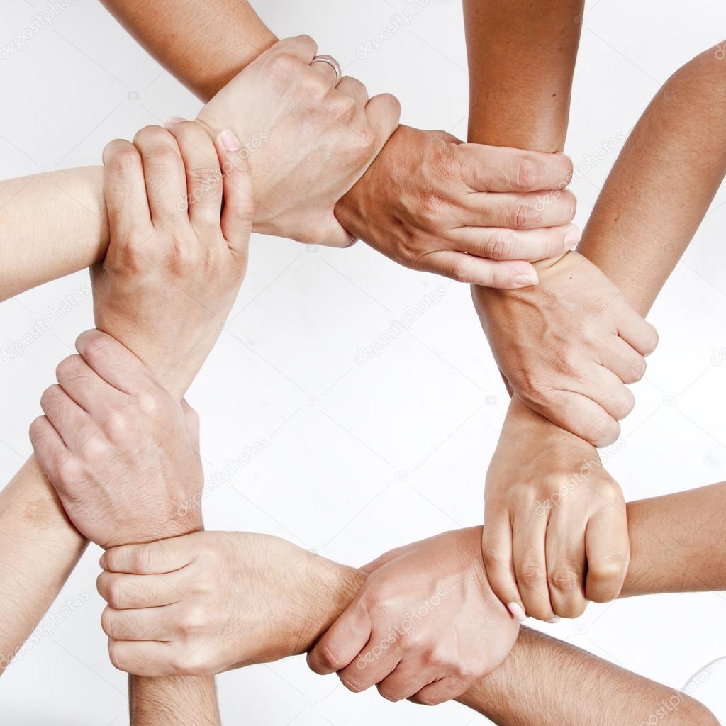 Small group of business people joining hands