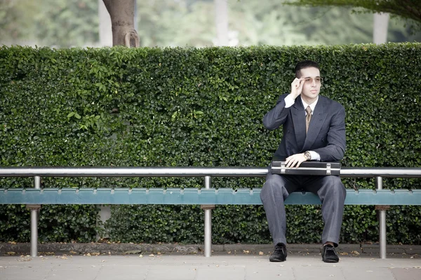 Businessman waiting at the bus stop — Stock Photo, Image