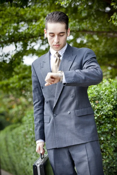Businessman looking at his watch Stock Image