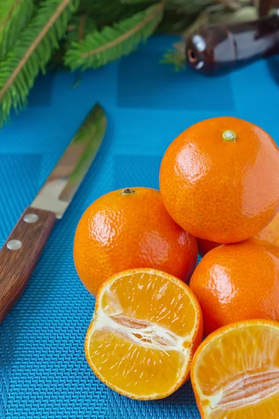 Tangerines on a blue tablecloth — Stock Photo, Image