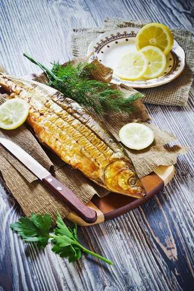 Smoked fish with lemon, dill and parsley — Stock Photo, Image