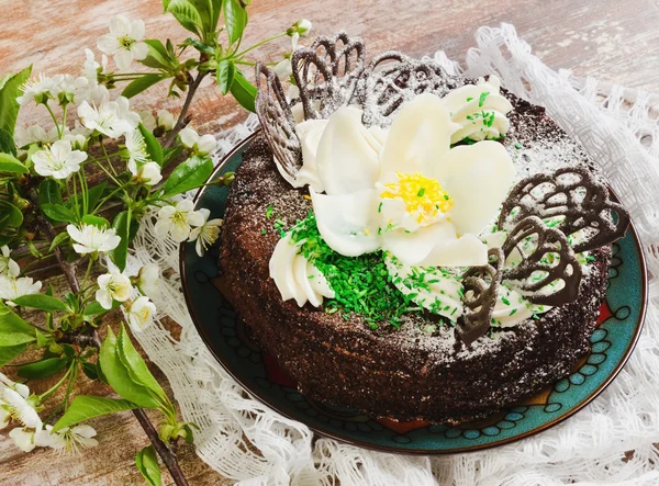 Chocolate cake with white flower — Stock Photo, Image