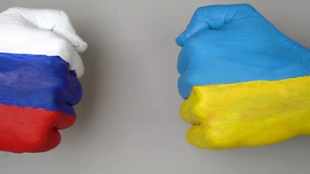 ウクライナとロシアの旗灰色の背景で互いにパンチに手にフラグを立てる ウクライナ対世界大戦の危機の概念でロシア 拳は互いに触れない — ストック動画