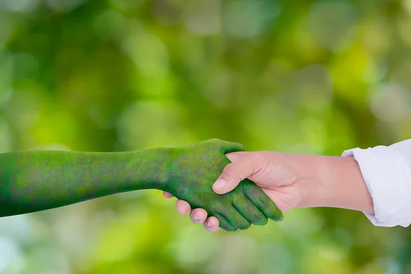 Environment earth day, Hand shake between human hands and nature, Loving the environment, Forest conservation concept, Ecology and Nature concept.