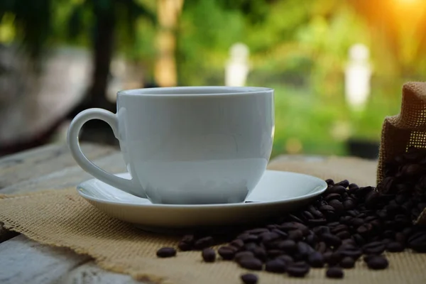 Hot Coffee Cup Coffee Beans Roating Wooden Table Green Garden — Stock Photo, Image