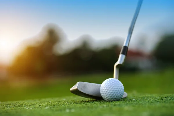Golf sopaları ve golf topları yeşil çimlerde sabah güneşli güzel bir golf sahasında. Golf sahasındaki delikte bir top..                                